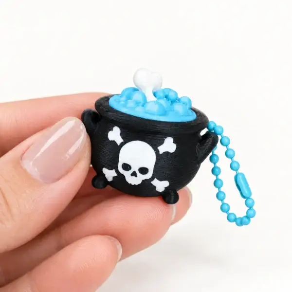 Spooky Halloween Clickers, Skull cauldron, a small printed item in the pictured colors