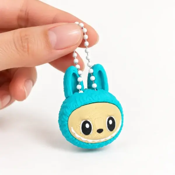 Labubu Clicker, Teal, a small printed item in the pictured colors