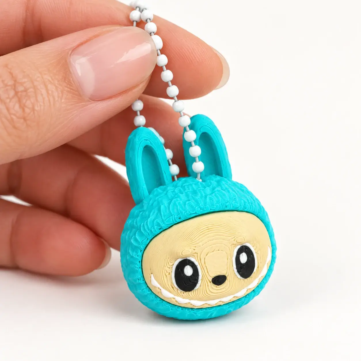 Labubu Clicker, Teal, a small printed item in the pictured colors