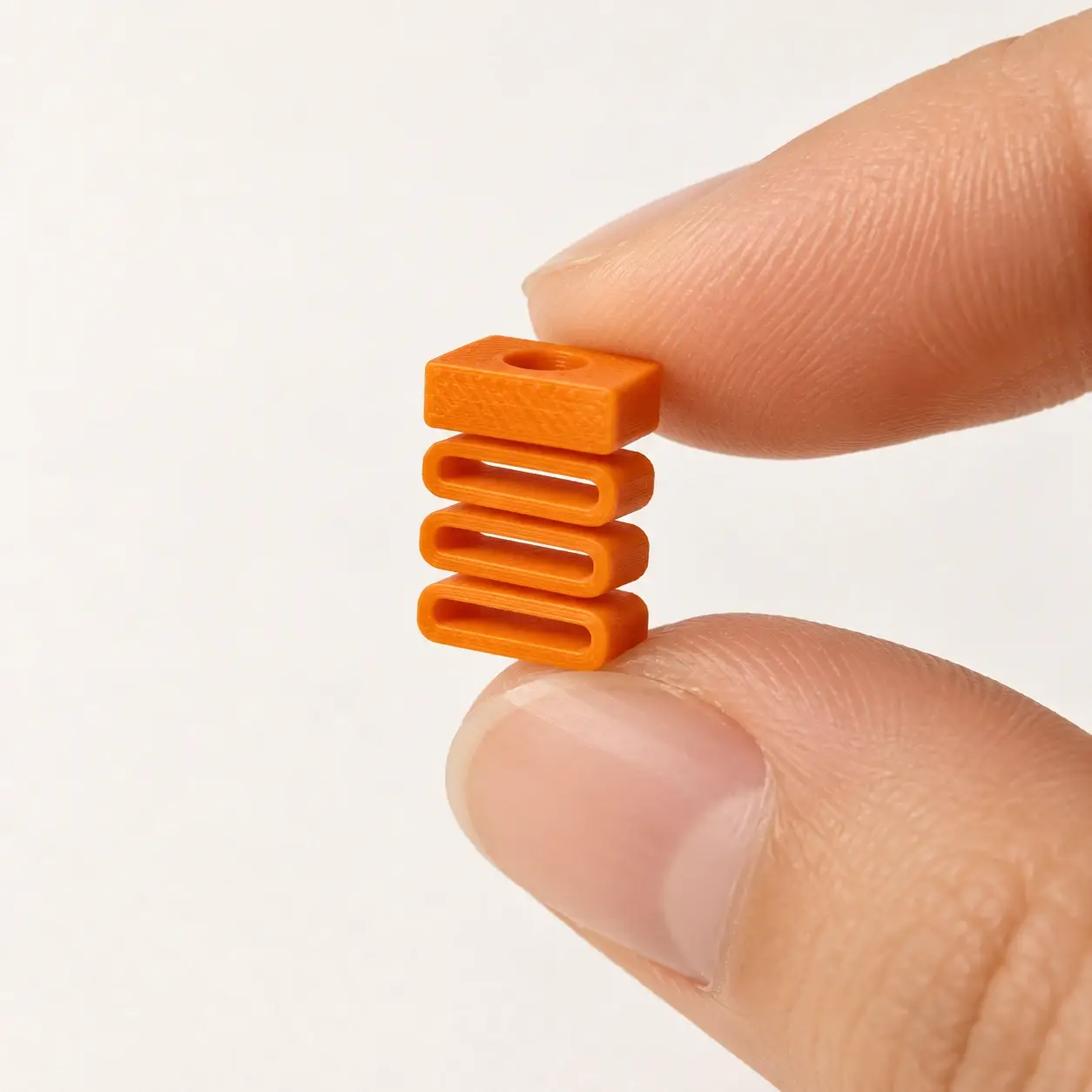 Silent Dummy Clicker Insert, Orange insert, a small printed item in the pictured colors