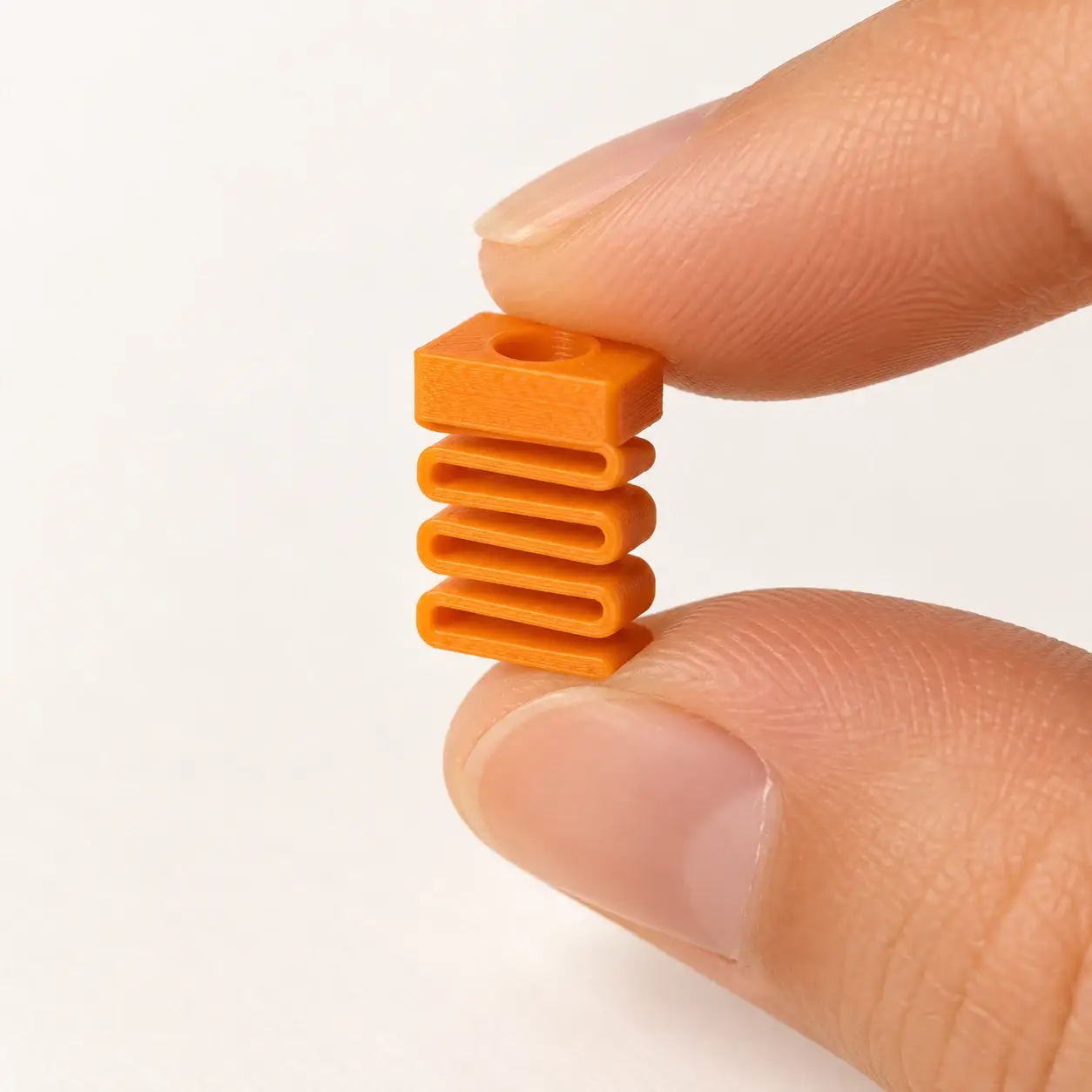 Silent Dummy Clicker Insert, Orange insert, a small printed item in the pictured colors