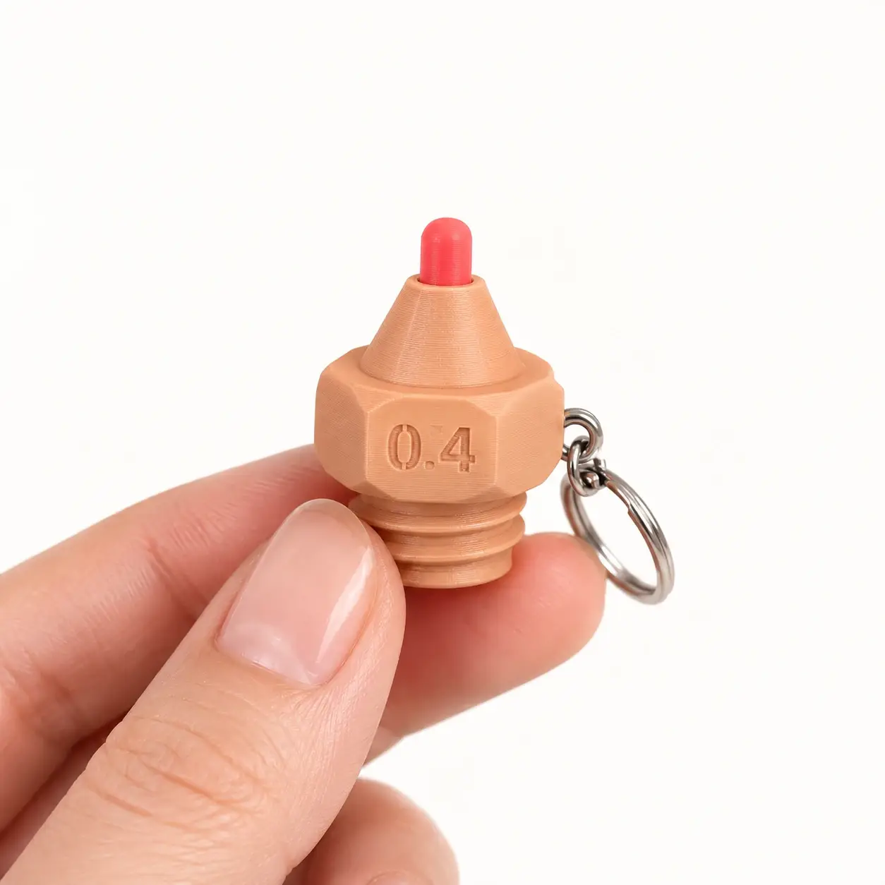 Printer Nozzle Clicker, Peach - red tip, a small printed item in the pictured colors