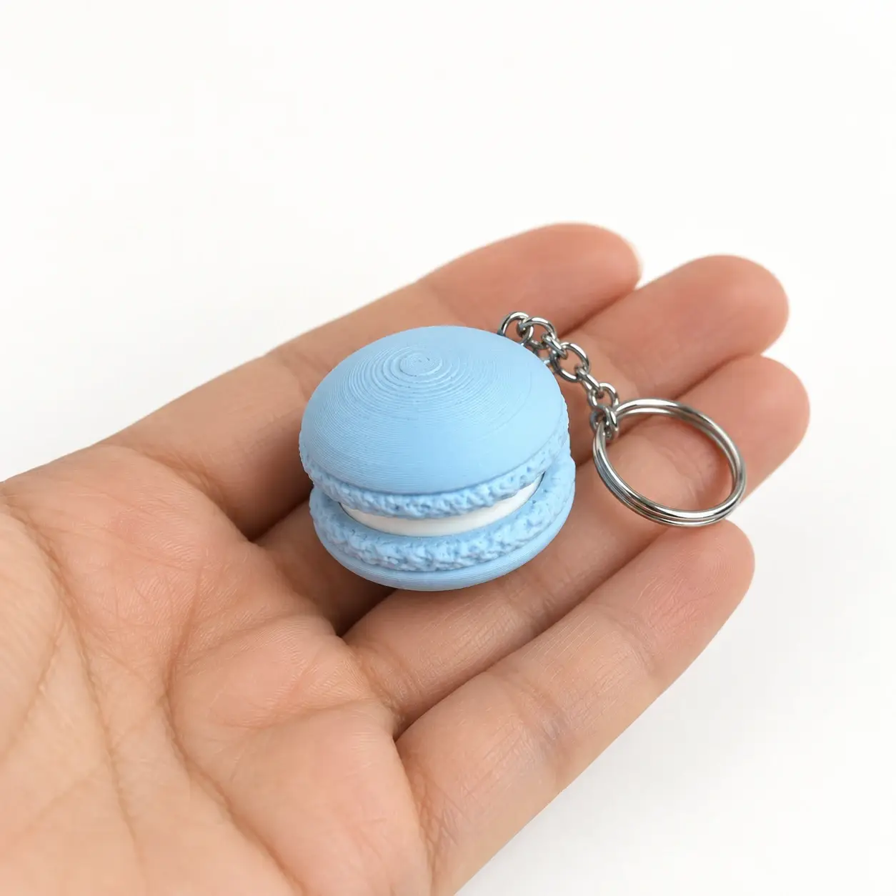 Macaron Clicker, Blue, a small printed item in the pictured colors