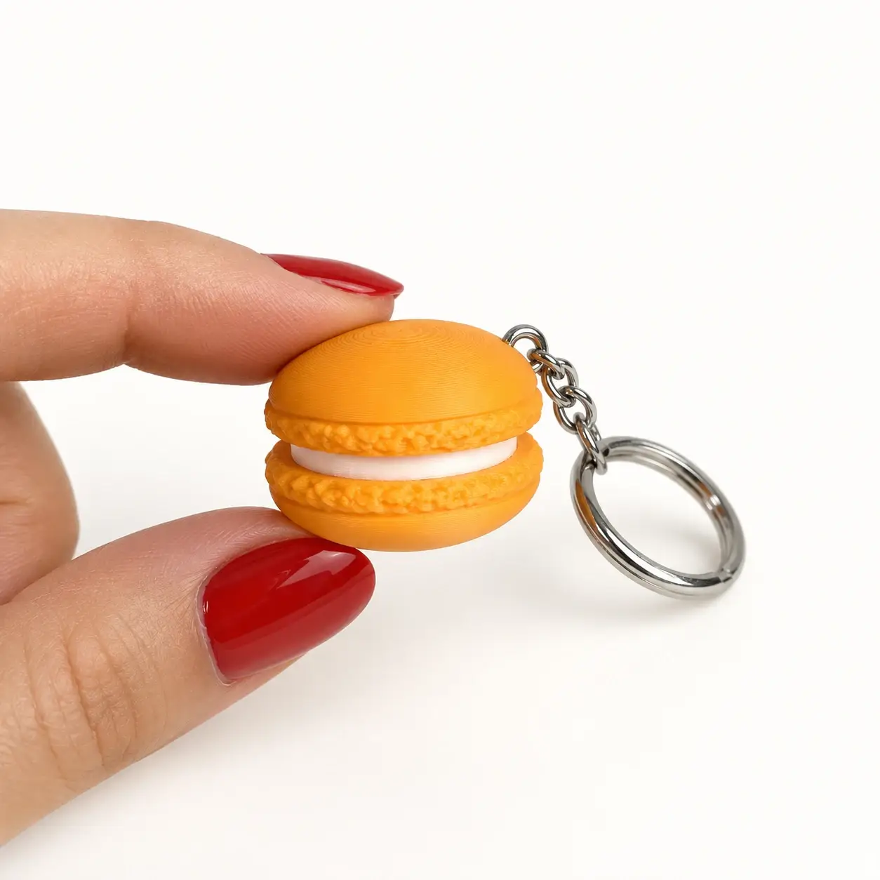Macaron Clicker, Orange, a small printed item in the pictured colors