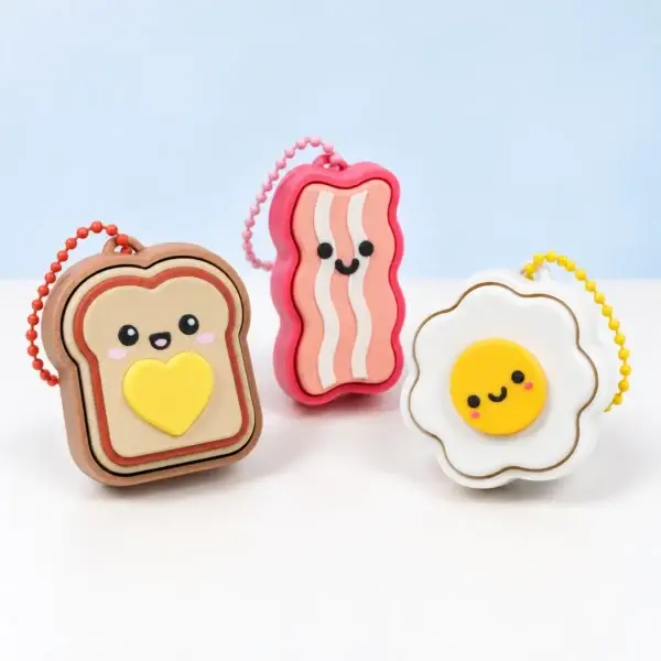 Toast, bacon and egg clicker keychains shown together